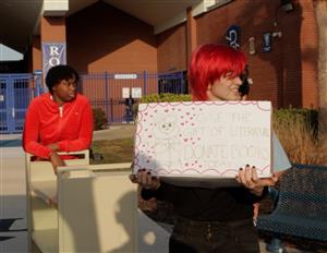 Student holding a bin of books